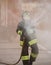 firefighter in action with the foaming agent during an emergency