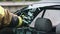 Firefighter beraking glass on car window extricate trapped victim from the car