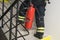 A firefighter climbs the stairs and carries a red fire extinguisher to extinguish fires in electrical equipment