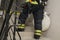 A firefighter climbs the stairs with equipment for extinguishing and opening doors