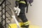 A firefighter climbs the stairs holding a teddy bear toy in his hand