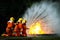 Firefighter Concept. Fireman using water and extinguisher to fighting with fire flame. firefighters fighting a fire with a hose an