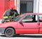 Firefighter cuts the windshield of car with a Hacksaw
