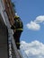 Firefighter descends the ladder from the roof - demonstration exercise