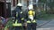 Firefighter dressed in uniform and an oxygen mask. A fire in an apartment building.