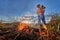 Firefighter ecologist working in field with wildfire.