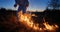 Firefighter ecologist working in field with wildfire.