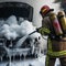 Firefighter Extinguish Burning melting ev electric Car with chemical foam, on a parking lot daytime