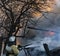 Firefighter extinguishes the fire. Fireman holding a hose with w