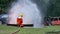 Firefighter fighting with fire flame protection property. Fireman wear hard hat, body safe suit uniform for protection from fire o