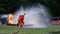 Firefighter fighting with fire flame protection property. Fireman wear hard hat, body safe suit uniform for protection from fire o