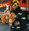 Firefighter holding child boy to save him in fire and smoke,Firemen rescue the boys from fire