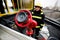 Firefighter holds a fire suppression system hydrant on a hospital helipad during a cold cloudy winter day