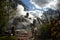 Firefighter hoses down a fire in a thatched cottage