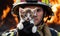 firefighter with a kitten in his arms on the background of fire