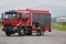 A firefighter meticulously prepares a modern firetruck for a mission to evacuate and respond to dangerous situations