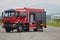 A firefighter meticulously prepares a modern firetruck for a mission to evacuate and respond to dangerous situations