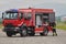 A firefighter meticulously prepares a modern firetruck for a mission to evacuate and respond to dangerous situations