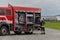 A firefighter meticulously prepares a modern firetruck for a mission to evacuate and respond to dangerous situations