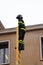 Firefighter over a high wooden staircase during a rescue exercis