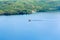 Firefighter plane collecting water on lake to put out a forest fire.