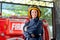 Firefighter with protective clothes stand with confidence action and smile in front of fire truck. She also smile with happy and