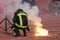 Firefighter putting down football fans\' torches fire