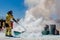 Firefighter putting out a fire with a fire extinguisher