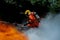 Firefighter Rescue training to stop burning flame, Fireman wear hard hat and safety uniform suit for protection burn using axe to