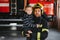 A firefighter take a little child boy to save him. Fire engine car on background. Fireman with kid in his arms