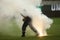 Firefighter tries to extinguish torches thrown on the grass