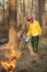 Firefighter using a controlled fire in the forest