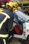 Firefighter using jaws of life at a car crash