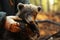 A firefighter or volunteer in a protective suit holds in his arms a bear cub