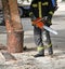 Firefighter works with a chainsaw outdoor