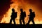 Firefighters battling intense flames, silhouetted against the fiery backdrop