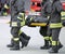 Firefighters carry a wounded man on a stretcher