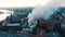 Firefighters extinguish a burning building, aerial view