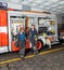 Firefighters Leaning On Truck At Fire Station