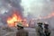 Firefighters prepare pour water on a building on fire