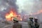 Firefighters prepare pour water on a building on fire