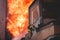 Firefighters put out large massive fire blaze, group of fire men in uniform during fire fighting operation in the city streets,