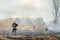 Firefighters spray water to wildfire. Fireman working hard to put out the bush fires