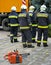 Firefighters standing next to a crane