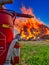 Firefighting vehicle is in the foreground of a large, blazing wildfire.