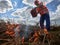 Fireman ecologist fighting fire in field