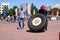 A fireman in a fireproof suit runs and turns a large rubber wheel in a fire fighting competition, Belarus, Minsk, 08.08.2018