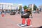 A fireman in a fireproof suit runs and turns a large rubber wheel in a fire fighting competition, Belarus, Minsk, 08.08.2018