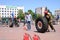 A fireman in a fireproof suit runs and turns a large rubber wheel in a fire fighting competition, Belarus, Minsk, 08.08.2018