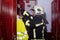 Fireman with a helmet in a galvanized steel locker taking a jacket